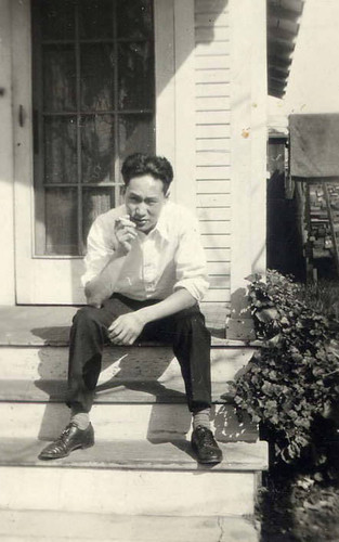 Man seated on the steps of a front porch