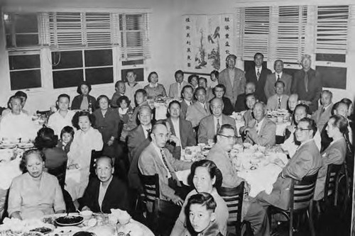 A large dinner gathering in the Shangri-La Restaurant on Chung King Road; pictured among the crowd are Gee Kee Ward, Yee Good Gal, Ann Yin Gee, Leland Wong; taken in Los Angeles, on the occasion of Gee Kee Ward's birthday