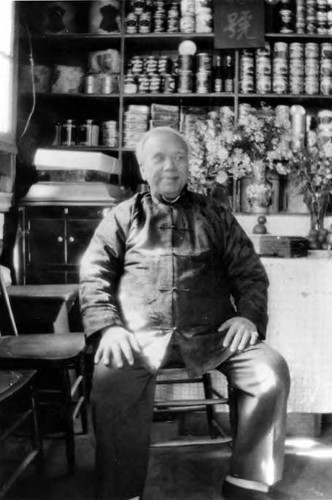 Grandpa Soo Hoo Leung in his store on Apablasa Street. "Sang Yuen." We pasted labels on the cans with home-made flour and water. Chinese New Year--see the candy dish on the table