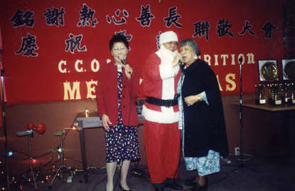 Los Angeles CCOA Nutrition Christmas party. Nancy Taneka, Santa Claus and Lily Chan singing carols