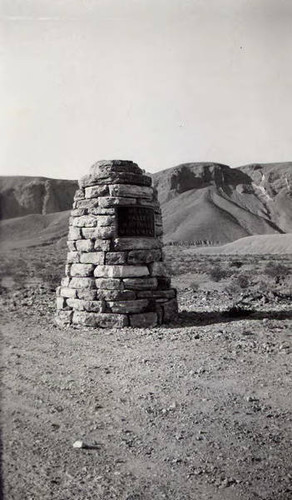 Monument with a plaque that reads "Death Valley National Monument"