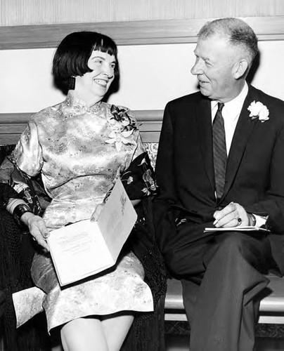 Man and woman seated inside the Simpson building