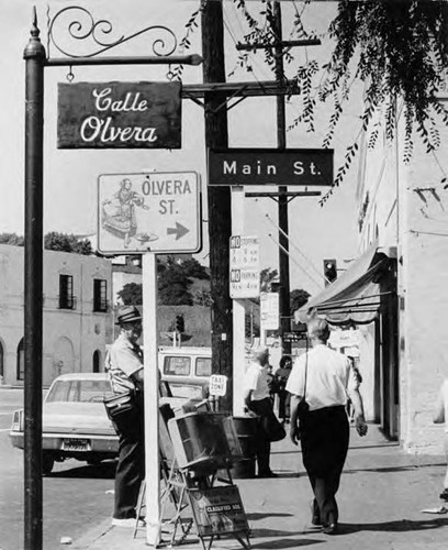 "Calle Olvera," "Olvera Street," "Main Street" signs at the Main Street entrance to Olvera Street