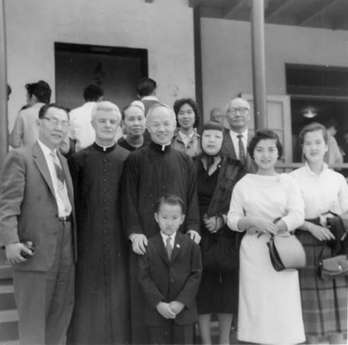 Catholic Center, Lily Lum Chan and others standing with clergy