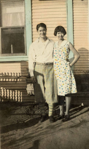 Dorothy and her boyfriend Jake standing outside of a house