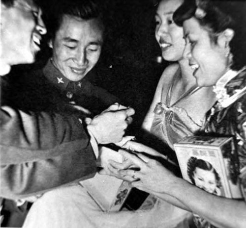 A treat for the cadets: The girls brought boxes of candied coconuts, preserved fruits, ginger and lichee nuts. When they opened the packages, the boys mobgbed them. p.29 of Look magazine