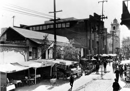 "Avila Adobe andOlvera Street, Los Angeles," Olvera Street side view of Avila Adobe, Plaza Substation, and Methodist Church, with shops and people