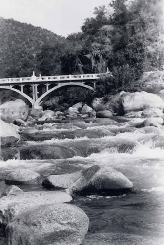 Photo of a river with bridge in background