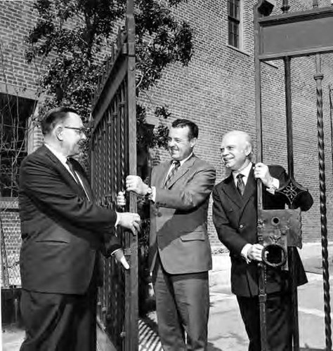 Hubert Laughen and Hernando Courtright are opening the Sanchez Street iron gate