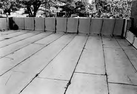 One of eight photographs of puestos at the Macy end of Olvera Street. The photographs incluse views of the roofs and detail shots of the brick/adobe walls