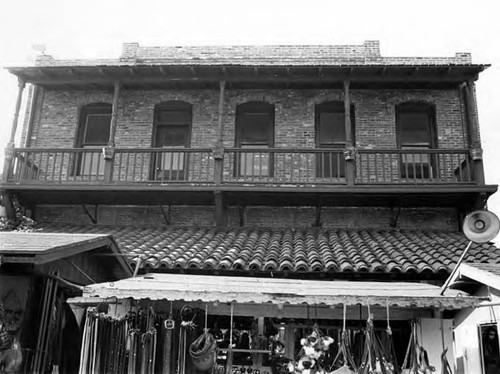 Sepulveda House, Olvera Street side, with second floor balcony and puestos in view