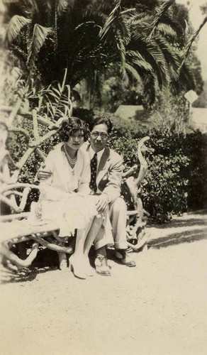 At Catalina Island, Birdie Ching and Phil sit on a bench in the aviary