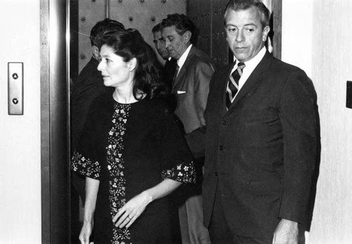 Man and woman coming from the elevator at the reception for the President of Mexico