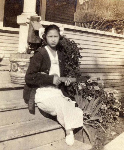 Ve before she was married, sitting on the steps with a ukulele