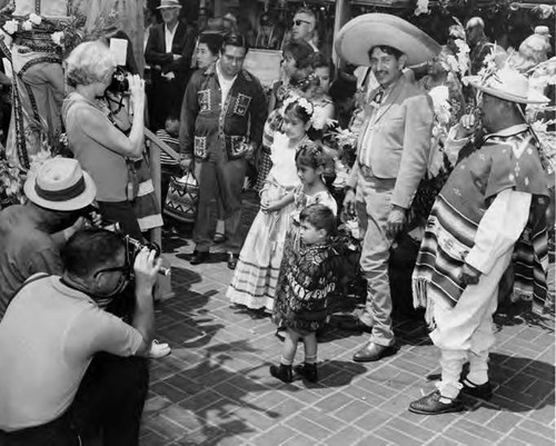 Group taking pictures of group in Mexican costume