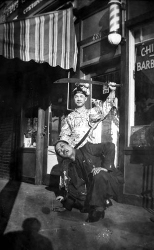 "Headchoppers" on Spring Street in front of a barber shop and to the left Tom's curio store, Tom G. costume