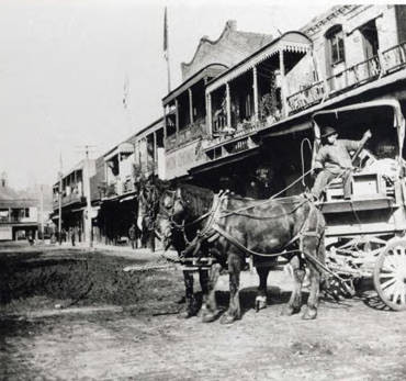 Chinese produce peddler on a wagon with two horses on Apablasa Street in Chinatown