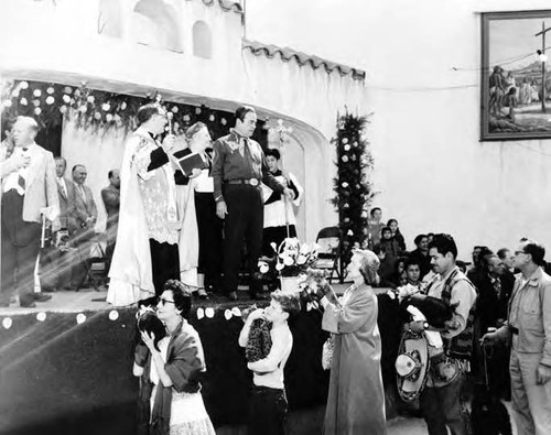 Procession passing in front of priest