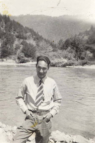 Photo of a young man posed in front of a river