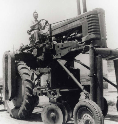 Man riding a John Deer tractor