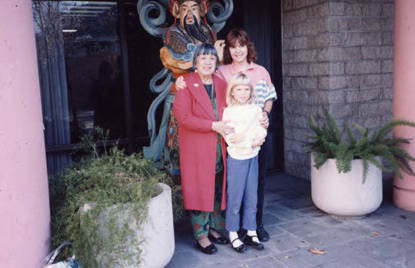 Photo taken at the CCOA Nutrition Center entrance, Lily Lum Chan stands with "Aggie" and her daughter