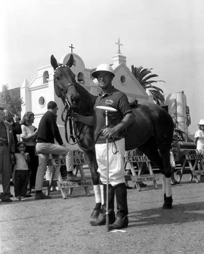 Man in polo gear with polo pony