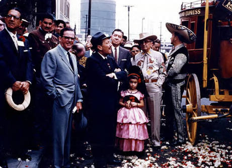 Close up of crowd next to a stage coach in front of Simpson building