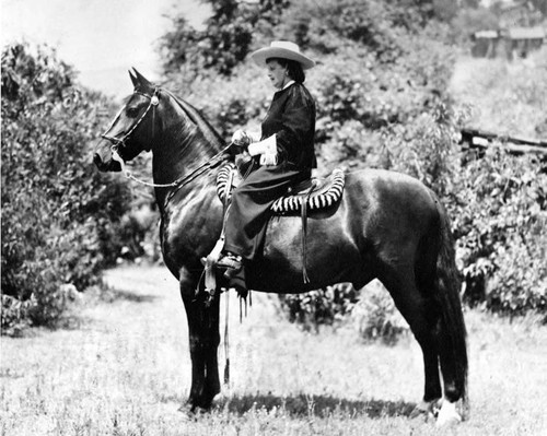 Mrs. Christine Sterling "Mother of Olvera Street" with her favorite horse "Mexico."