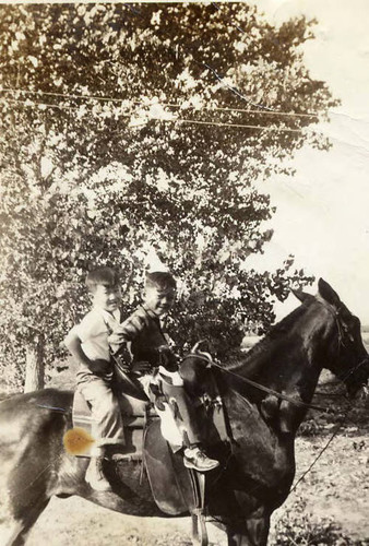 Roger and Rodney Low riding a horse together