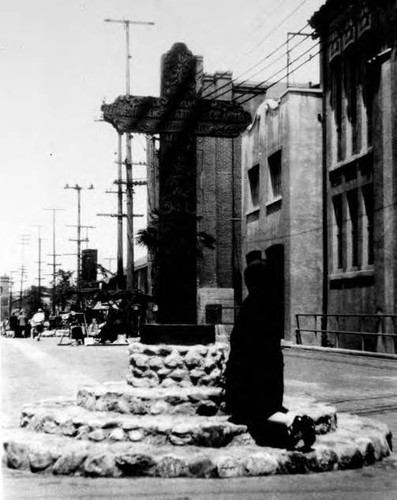 Postcard, woman kneeling at foot of cross