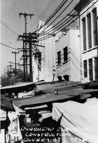 Overhead electrical construction on Olvera Street