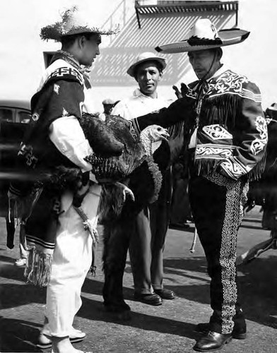 Three men with a turkey