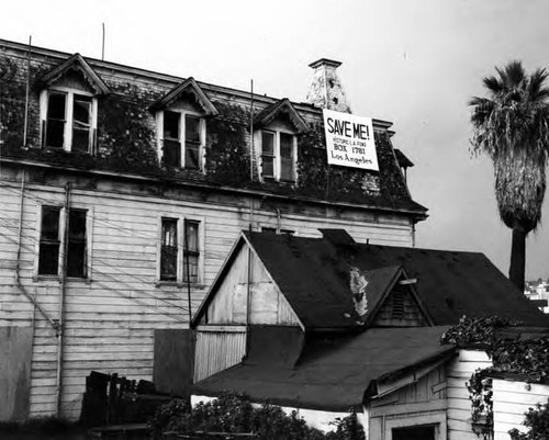 Rochester house with sign "Save Me! Historic Los Angeles Fund"