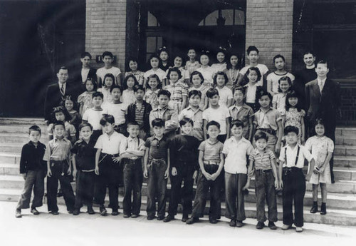 Catholic Chinese School group photo. Included are the principal and education director, Stanley Chan, the teacher, George Ching and Reverend John F. Cowhig