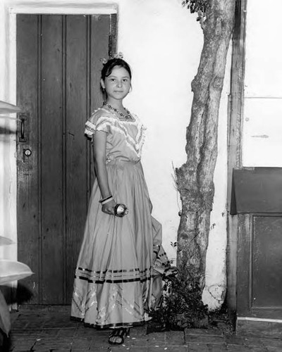 Photograph taken of a girl standing by a door