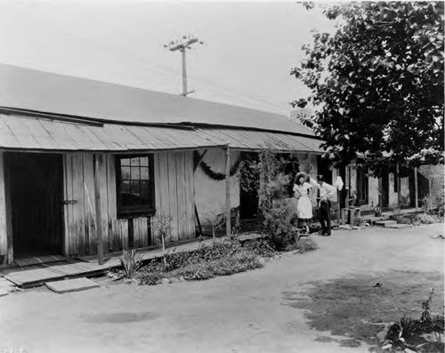 Photograph of Avila Adobe patio, a man and a woman stand outside