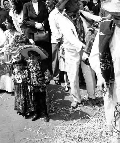 Two children going in front of crowd