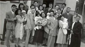 Photo taken after the baptism ceremony at the Los Angeles Chinese Congregationalist Church. Left to right are Willington Kwan with wife Helen and baby Teddy, Mr. and Mrs. Russell Fong and baby, Lawrence and Hazel Ho with baby Loren, and Reverend Ivan Wong. Peggy and Milton Quon with their baby Michael are above Lawrence Ho