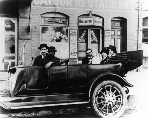 Family in car in front of Gavour Restarant