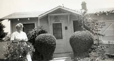 Jake Siu's mother in front of the house