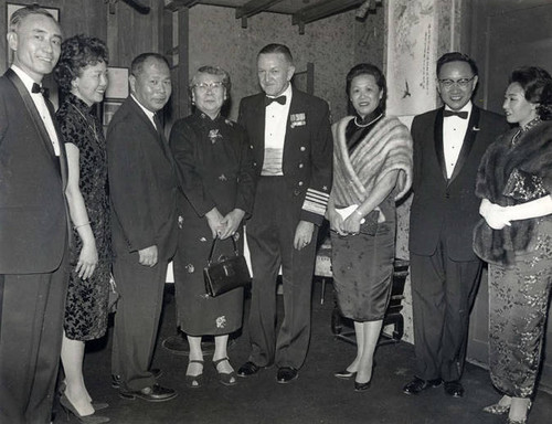 Photo of (from left to right) Dolores Wong, Wilbur Woo, Mrs. David Woo, U.S. official, Barbara Wong, Delbert Wong