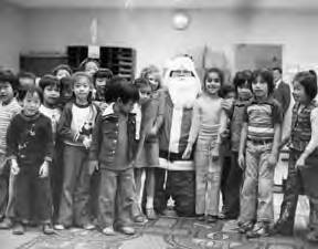 Santa Philip posed with a group of children at Castelar School