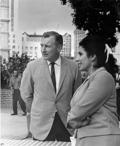 William Probert, El Pueblo Director, talking to a woman in the Plaza