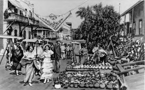 3X5 hand colored postcard of Olvera Street looking north. People and wares in foreground