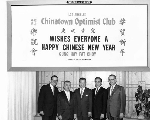 A billboard featuring Mayor Norris Poulson, President Tommy Enriquez, Delbert Wong and Councilman James Harvey Brown