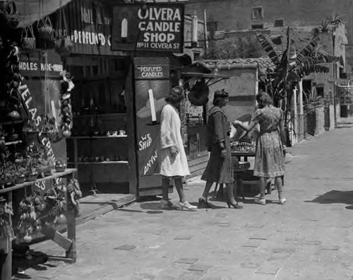 Three women outside of the Olvera Candle Shop on Olvera Street