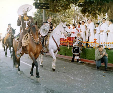 Mario Valadez in front of Priest's stand with horses passing by