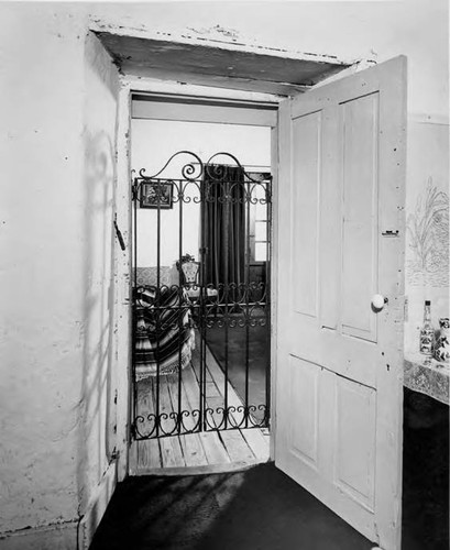 Doorway into room with chairs in Avila Adobe