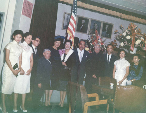 From left to right the daughter of Poy Wong, Barbara Wong, Poy Wong, Y.C. Hong, Mabel Hong, Mrs. Fong, Senator Hiram Fong at CCBA