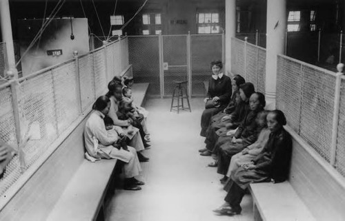 Chinese women and children seated at the immigration station on Angel Island